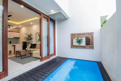 a swimming pool in the middle of a house at Vienna Villas by Great Bali Villas in Seminyak