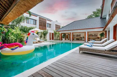 a pool with an inflatable unicorn swimming in a house at Vienna Villas by Great Bali Villas in Seminyak
