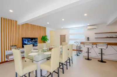 a dining room with a glass table and chairs at Vienna Villas by Great Bali Villas in Seminyak