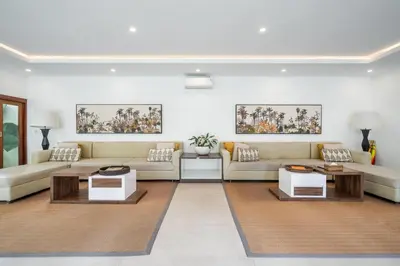 a living room with couches and tables at Vienna Villas by Great Bali Villas in Seminyak