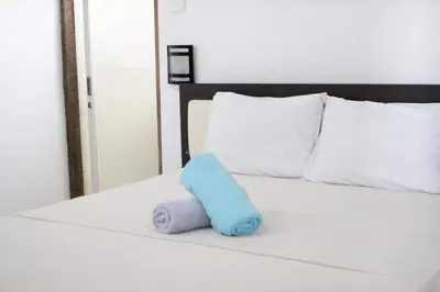 a blue towel sitting on top of a bed at Capricorn Villa in Seminyak