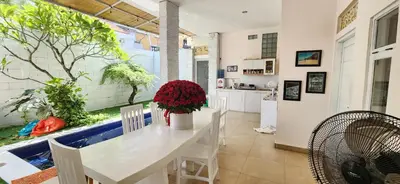 a kitchen and dining room with a large window with an aquarium at Capricorn Villa in Seminyak