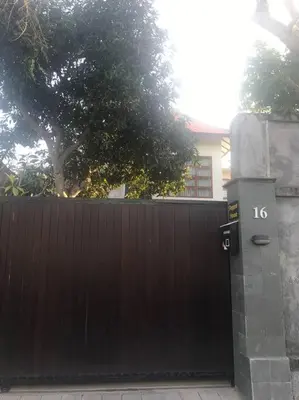 a black fence with a gate with the number on it at 2 BR Pepper House Villa near GWK Jimbaran - garden view in Jimbaran