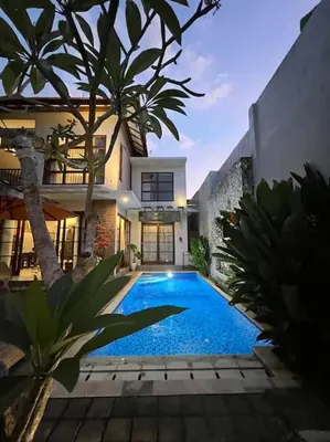 a swimming pool in front of a house at 2 BR Pepper House Villa near GWK Jimbaran - garden view in Jimbaran