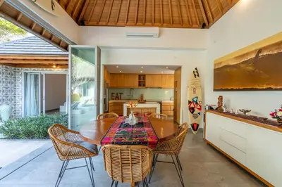 a kitchen and dining room with a wooden table and chairs at Villa Becca 4 Bedroom at Seminyak near to the Beach in Seminyak
