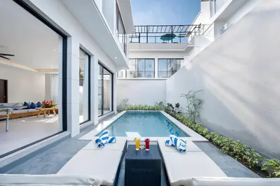 a swimming pool in the middle of a house at Canggu Villa Go by Nagisa Bali in Canggu