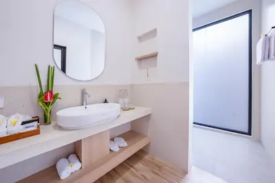 a bathroom with a sink and a mirror at Canggu Villa Go by Nagisa Bali in Canggu