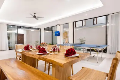 a dining room with a table and chairs at Canggu Villa Go by Nagisa Bali in Canggu