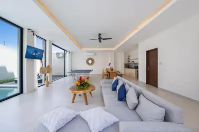 a living room with a couch and a table at Canggu Villa Go by Nagisa Bali in Canggu