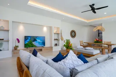 a living room with a couch and a tv at Canggu Villa Go by Nagisa Bali in Canggu