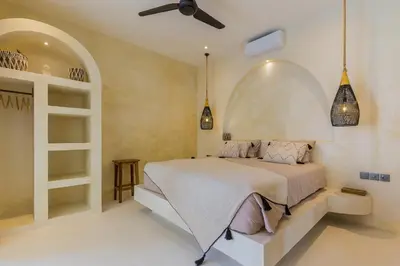 a bedroom with a bed and a ceiling fan at VILLA SALEYA with JACUZZI in Canggu