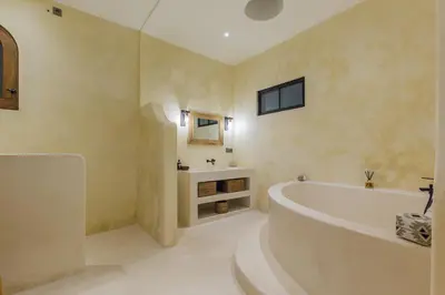 a bathroom with a tub and a sink at VILLA SALEYA with JACUZZI in Canggu