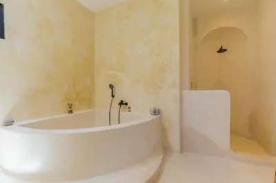 a white tub in a bathroom with a shower at VILLA SALEYA with JACUZZI in Canggu