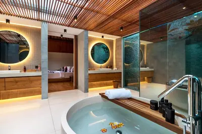 a large bathroom with a tub and a shower at Navya Villas in Canggu