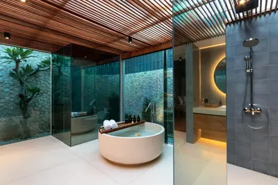 a bathroom with a tub and a shower at Navya Villas in Canggu