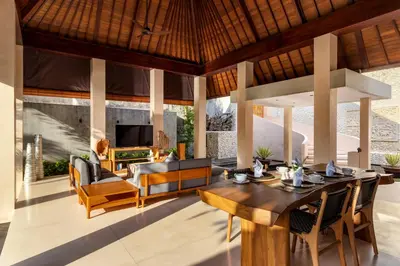 an open living room with a table and a couch at Navya Villas in Canggu