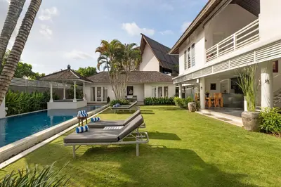 an image of a backyard with a swimming pool and a house at Kerta Rama Seminyak by Kerta Living in Seminyak