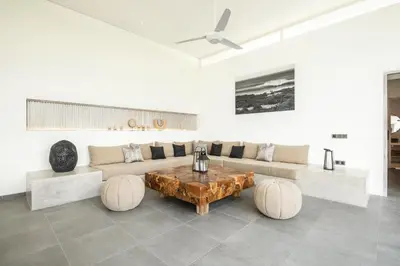 a living room with a couch and a table at Chic 4BR Villa, Canggu Hub, 800m to Beach Bliss in Canggu