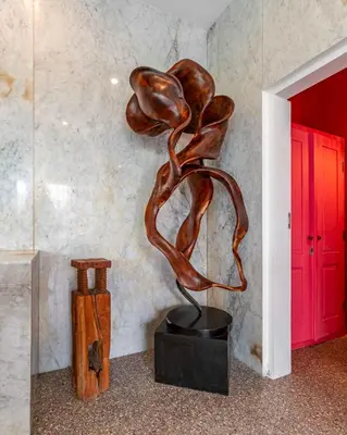 a bronze sculpture of a woman sitting on a table at Villa Ruku-Ruku - Modern 1BR Villa with AC Living Room & Private Pool - French Style Interior in Kerobokan