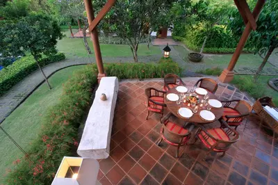 a patio with a table and chairs on a patio at Villa Hanani in Jimbaran