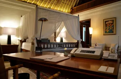 a room with a desk with a telephone and a bed at Villa Hanani in Jimbaran