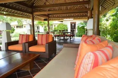 an outdoor patio with couches and a table at Villa Hanani in Jimbaran