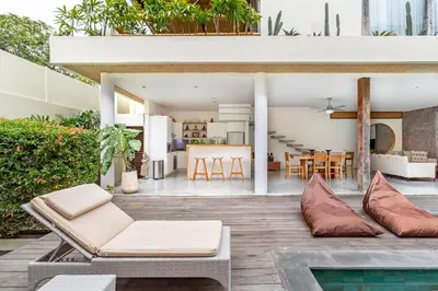 an open living and dining area of a house with a pool at Villa Ace - Modern 2BR Villa in Seminyak with Spacious Bedrooms, Bathtub & Private Pool in Seminyak