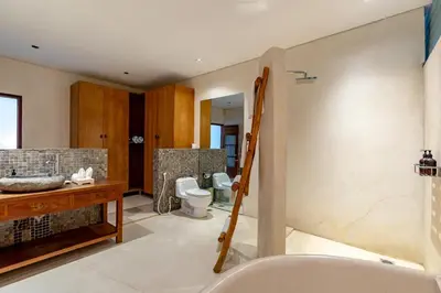 a bathroom with a shower and a toilet and a sink at Villa Ace - Modern 2BR Villa in Seminyak with Spacious Bedrooms, Bathtub & Private Pool in Seminyak