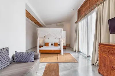 a bedroom with a bed with a canopy at Villa Ace - Modern 2BR Villa in Seminyak with Spacious Bedrooms, Bathtub & Private Pool in Seminyak