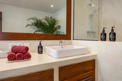 a bathroom with a white sink and a mirror at Villa Telma - Charming 2BR Villa in Central Seminyak, Walking Distance to Eat Street in Seminyak