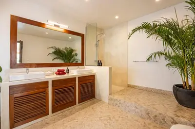 a bathroom with two sinks and a mirror at Villa Telma - Charming 2BR Villa in Central Seminyak, Walking Distance to Eat Street in Seminyak