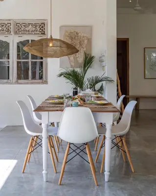 a dining room with a table and white chairs at Villa Telma - Charming 2BR Villa in Central Seminyak, Walking Distance to Eat Street in Seminyak