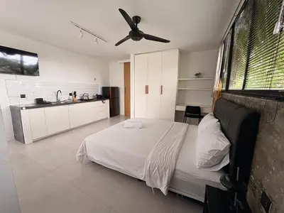 a bedroom with a bed and a ceiling fan at The Drupadi Apartments Studio Peka in Seminyak