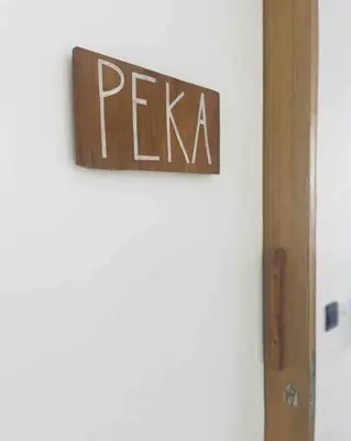 a sign that says pizza on a wall at The Drupadi Apartments Studio Peka in Seminyak