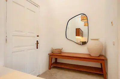 a mirror and a vase on a table in a room at House Sawah - Beautiful & Stylish 3BR Home with Jacuzzi Near Umalas and Seminyak in Kerobokan