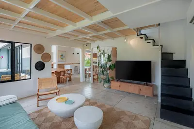 a living room with a tv and a couch at House Sawah - Beautiful & Stylish 3BR Home with Jacuzzi Near Umalas and Seminyak in Kerobokan