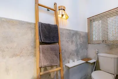 a ladder in a bathroom with a toilet and a light at House Sawah - Beautiful & Stylish 3BR Home with Jacuzzi Near Umalas and Seminyak in Kerobokan