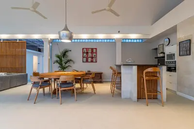 a kitchen and dining room with a wooden table and chairs at Villa Elea - Bright & Modern 2BR Villa in Seminyak with Private Pool and Sunset Rooftop in Seminyak