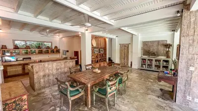 a large room with a wooden table and chairs at Villa Nak - Charming 4BR Family-Friendly Villa, Walking Distance to Seminyak Beach in Seminyak