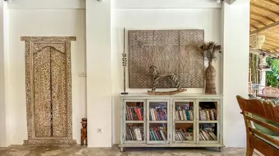 a room with a book shelf with books at Villa Nak - Charming 4BR Family-Friendly Villa, Walking Distance to Seminyak Beach in Seminyak