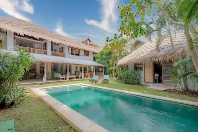 an exterior view of a house with a swimming pool at Villa Nak - Charming 4BR Family-Friendly Villa, Walking Distance to Seminyak Beach in Seminyak