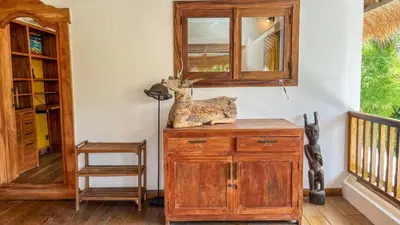 a room with a wooden dresser and a mirror at Villa Nak - Charming 4BR Family-Friendly Villa, Walking Distance to Seminyak Beach in Seminyak