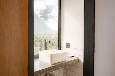 a bathroom with a white sink on a counter at Town House REX in Kuta