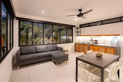 a living room with a couch and a table at Town House REX in Kuta