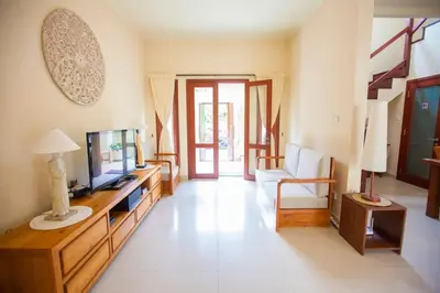 a living room with a television and a couch at Vibrant Getaway in Seminyak: Villa Buyaya in Seminyak