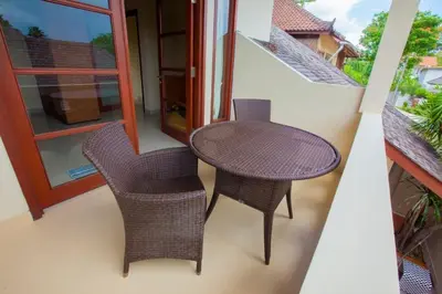 a small table and two chairs on a balcony at Vibrant Getaway in Seminyak: Villa Buyaya in Seminyak