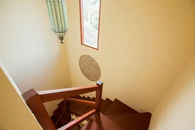a stairwell with a wooden rail and a window at Vibrant Getaway in Seminyak: Villa Buyaya in Seminyak