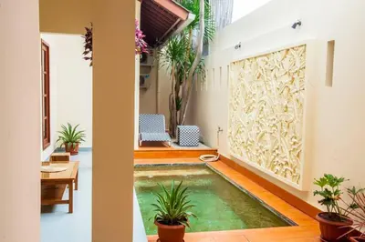 a pool in the middle of a room with plants at Vibrant Getaway in Seminyak: Villa Buyaya in Seminyak