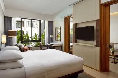 a hotel room with a bed and a flat screen tv at Courtyard by Marriott Bali Seminyak Resort in Seminyak