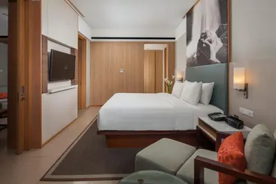 a hotel room with a bed and a television at Courtyard by Marriott Bali Seminyak Resort in Seminyak